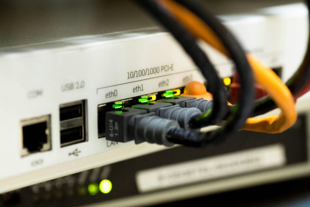 Close-up image of an Ethernet switch with multiple connected network cables.